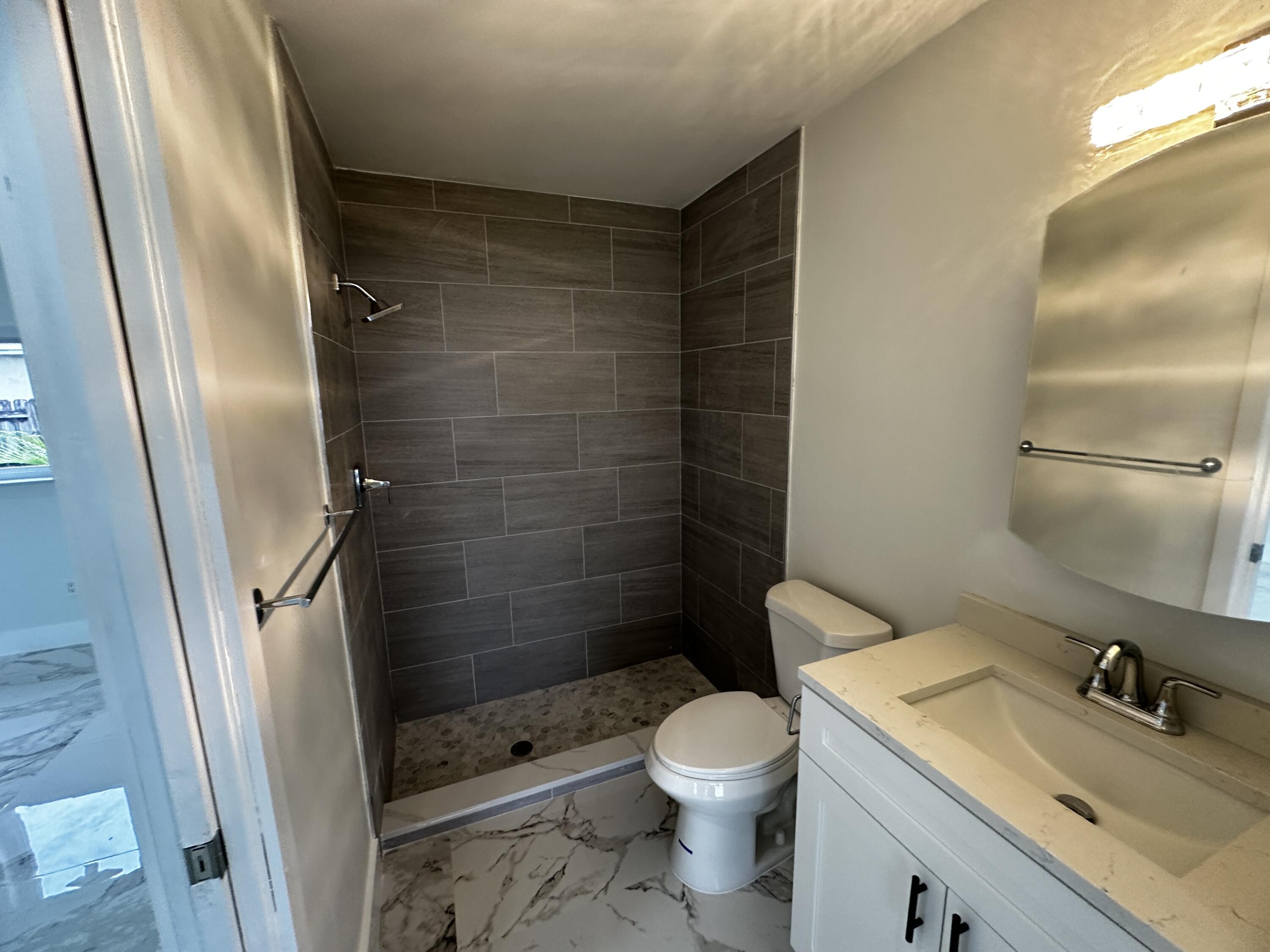 11150 Delta Circle Boca Raton, FL 33428 - Photo 9 of 17 a bathroom with a sink a toilet and shower