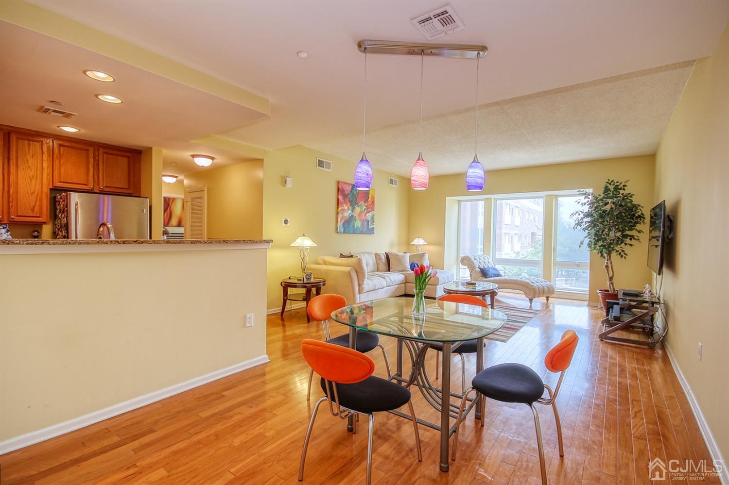 358 Rector Street, Unit 315 Perth Amboy, NJ 08861 - Photo 1 of 4 a view of a dining room with furniture window and wooden floor