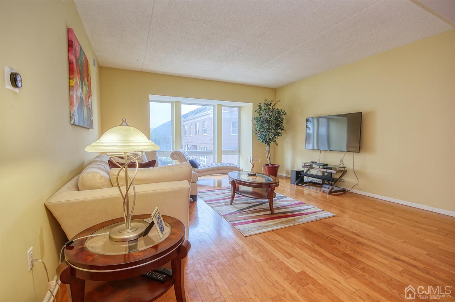 358 Rector Street, Unit 315 Perth Amboy, NJ 08861 - Photo 3 of 4 a living room with furniture and a table