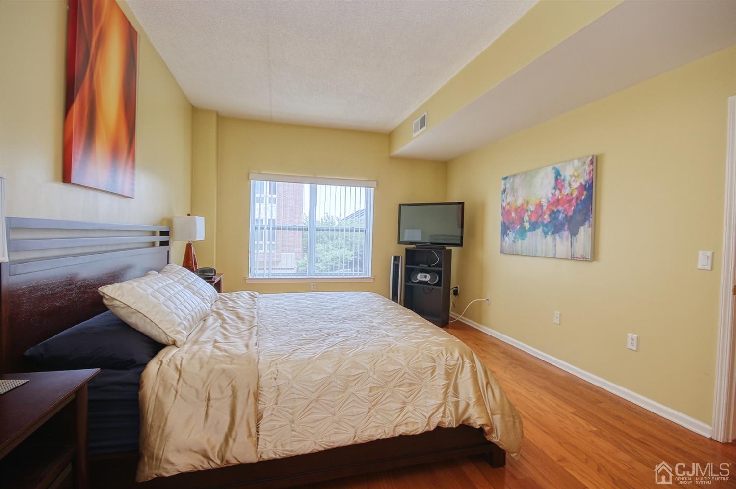 358 Rector Street, Unit 315 Perth Amboy, NJ 08861 - Photo 4 of 4 a bedroom with a bed and wooden floor