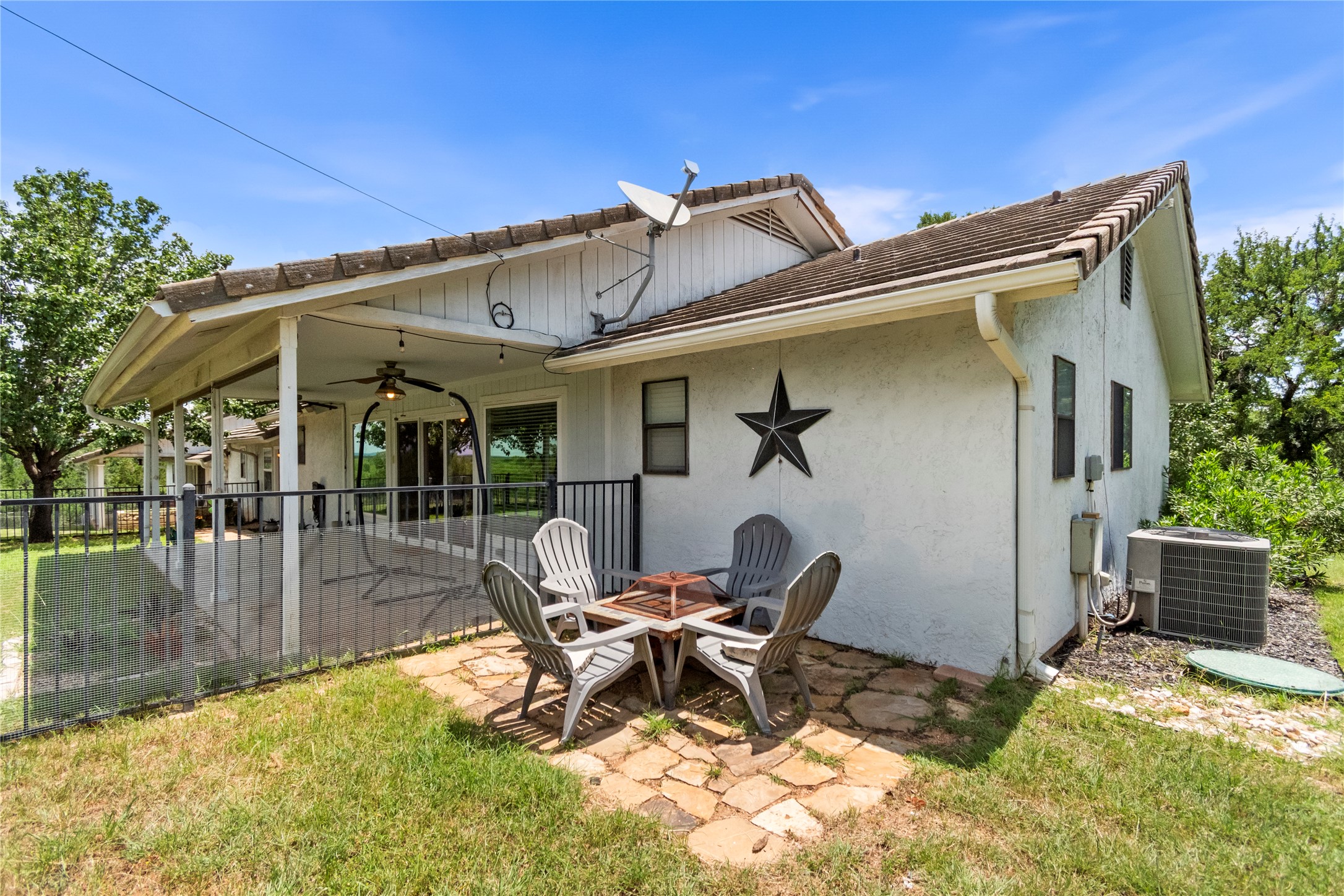 210 Teeoff, Unit B Horseshoe Bay, TX 78657 - Photo 32 of 38 A spacious covered patio invites outdoor enjoyment, alongside a charming stone-paved area for gathering.