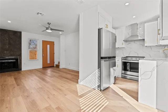 a view of a kitchen with a sink and refrigerator