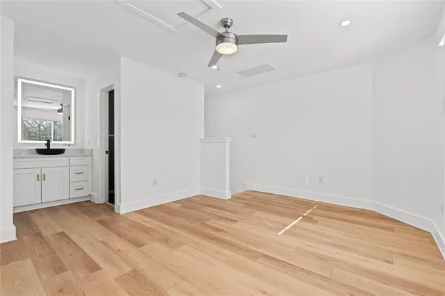 a view of a kitchen with wooden floor and a sink