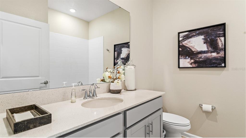 1106 James Paul Road Davenport, FL 33837 - Photo 13 of 21 a bathroom with a toilet a sink and mirror