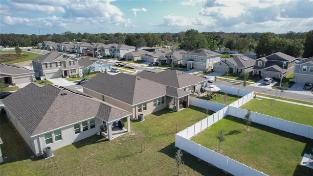an aerial view of residential houses with outdoor space