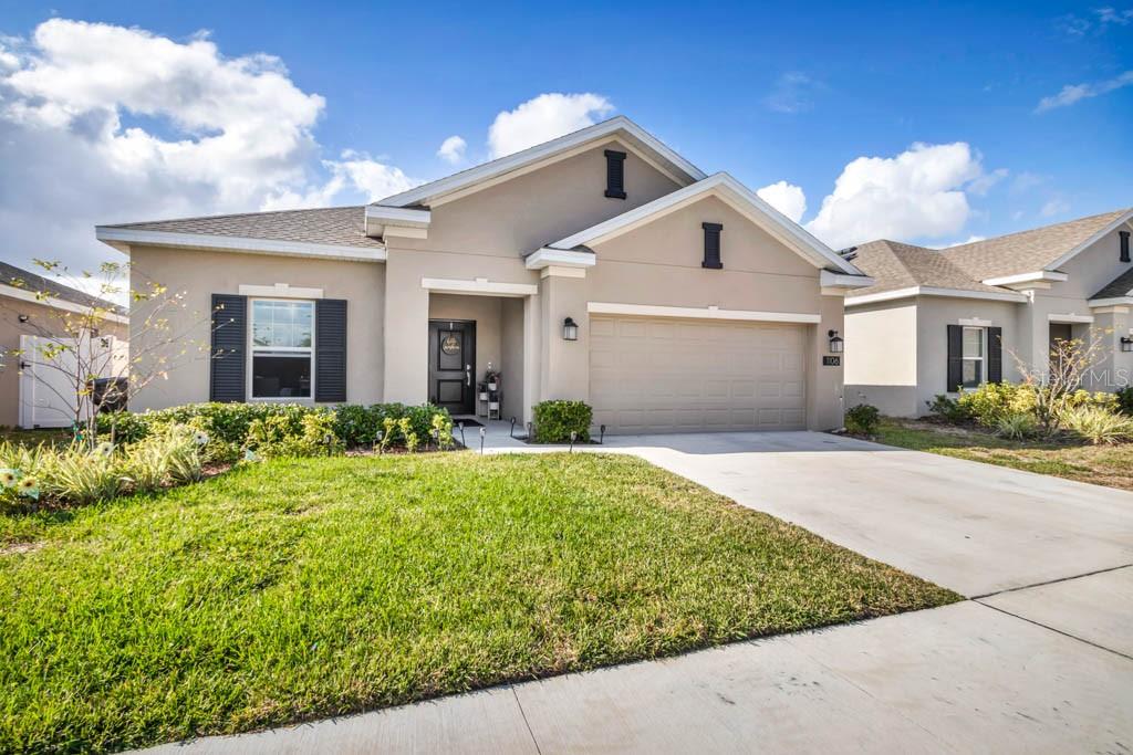 1106 James Paul Road Davenport, FL 33837 - Photo 2 of 21 a front view of a house with garden