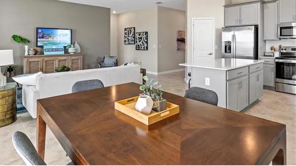 a living room with kitchen island furniture and a flat screen tv