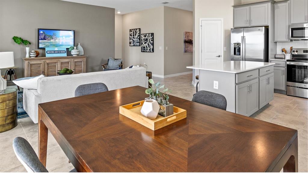 1106 James Paul Road Davenport, FL 33837 - Photo 6 of 21 a living room with kitchen island furniture and a flat screen tv