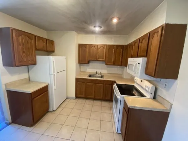 a kitchen with a cabinets and a stove top oven