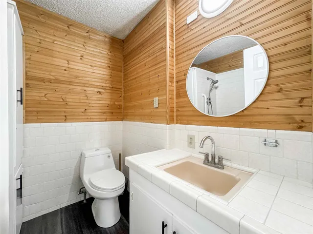 a bathroom with a toilet sink and mirror