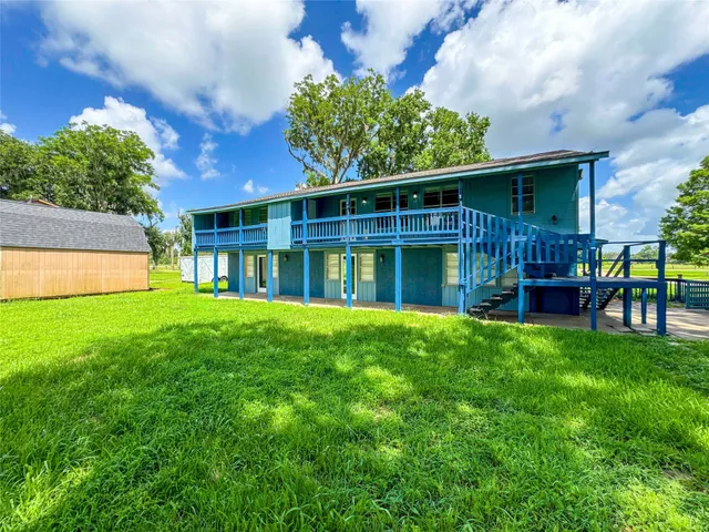 a view of house with backyard and a patio