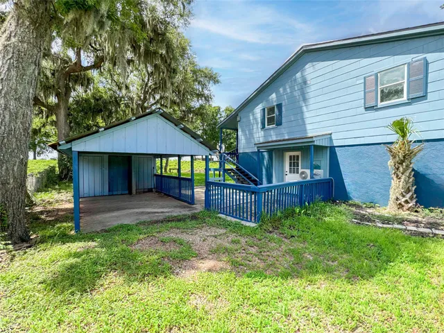a view of a house with a yard and plants