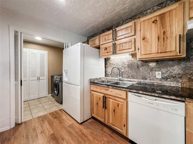 a kitchen with stainless steel appliances granite countertop a refrigerator stove and sink