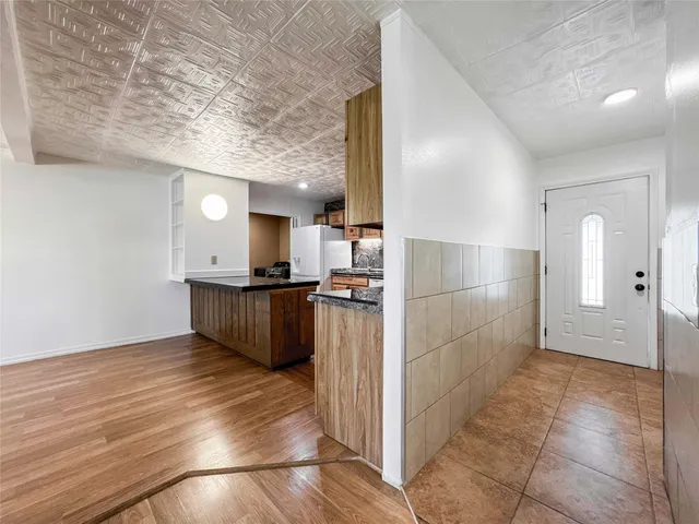 a view of kitchen with refrigerator and window