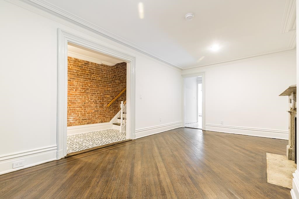118 Mercer Street Jersey City, NJ 07302 - Photo 15 of 33 a view of an empty room with wooden floor and a window