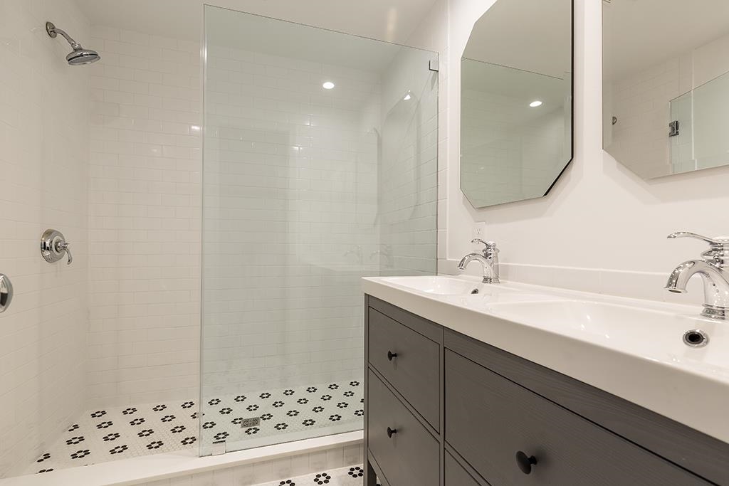 118 Mercer Street Jersey City, NJ 07302 - Photo 17 of 33 a bathroom with a sink and a mirror