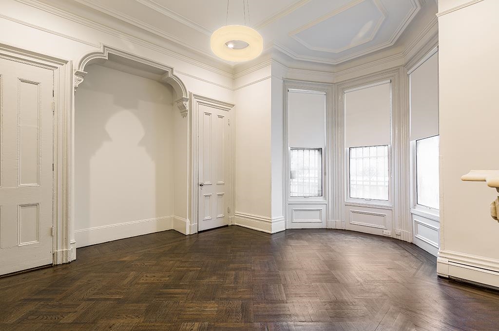 118 Mercer Street Jersey City, NJ 07302 - Photo 2 of 33 an empty room with wooden floor and windows