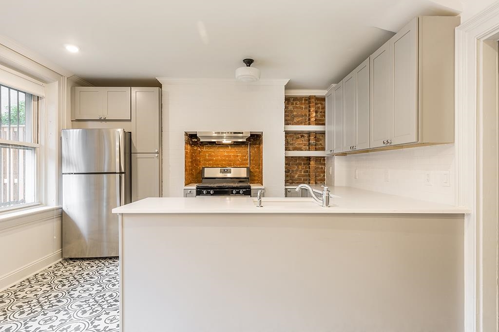 118 Mercer Street Jersey City, NJ 07302 - Photo 21 of 33 a kitchen with stainless steel appliances a refrigerator and a stove top oven