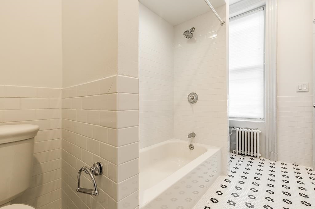 118 Mercer Street Jersey City, NJ 07302 - Photo 29 of 33 a bathroom with a bathtub and a shower