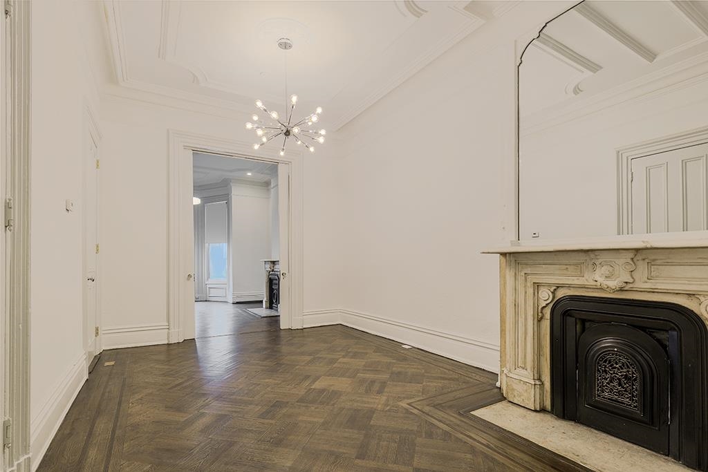 118 Mercer Street Jersey City, NJ 07302 - Photo 7 of 33 a view of a livingroom with a fireplace and a chandelier