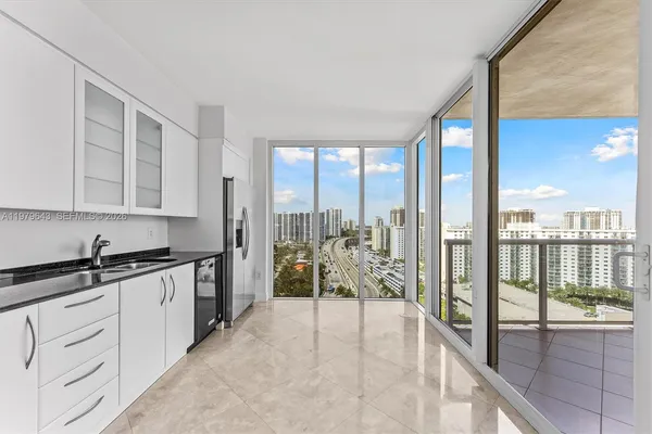 a kitchen with stainless steel appliances cabinets a sink and a refrigerator