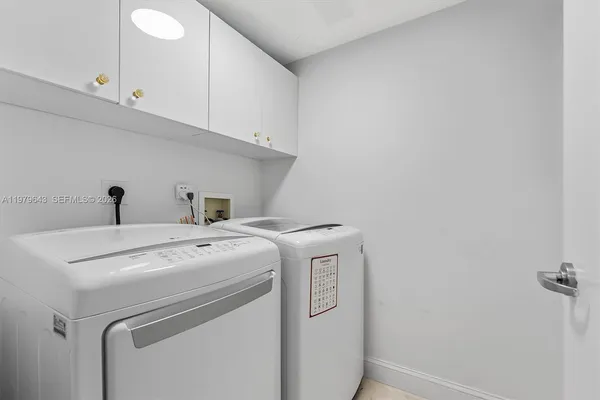 a living room with furniture and large windows