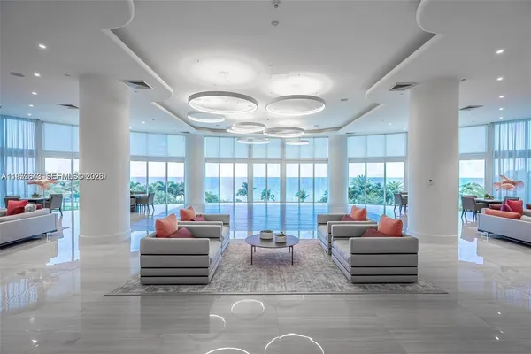 a kitchen with a stove and a view of living room
