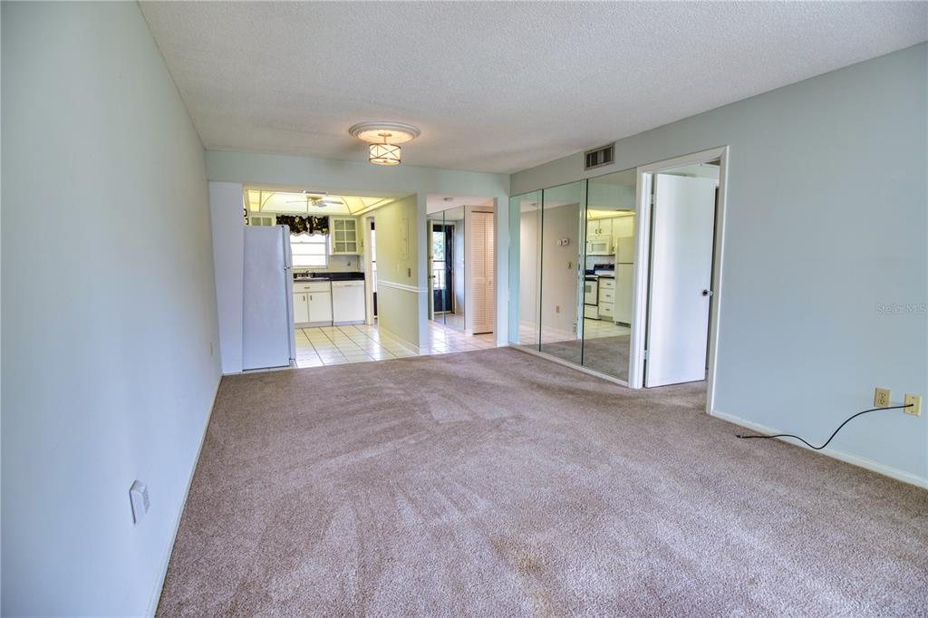 102 Capri Isles Boulevard, Unit 207 Venice, FL 34292 - Photo 12 of 25 a view of a hallway with wooden floor and a cabinet