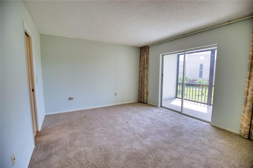 102 Capri Isles Boulevard, Unit 207 Venice, FL 34292 - Photo 13 of 25 a view of an empty room with a window