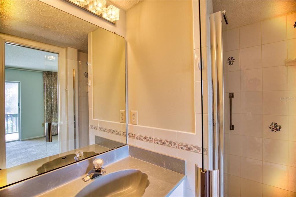 102 Capri Isles Boulevard, Unit 207 Venice, FL 34292 - Photo 16 of 25 a bathroom with a tub and a sink