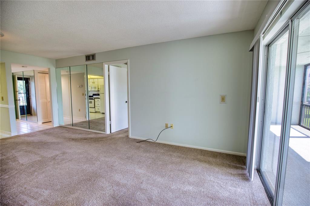 102 Capri Isles Boulevard, Unit 207 Venice, FL 34292 - Photo 17 of 25 an empty room with windows