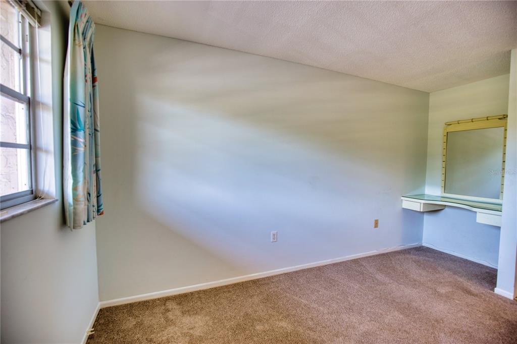 102 Capri Isles Boulevard, Unit 207 Venice, FL 34292 - Photo 19 of 25 an empty room with windows