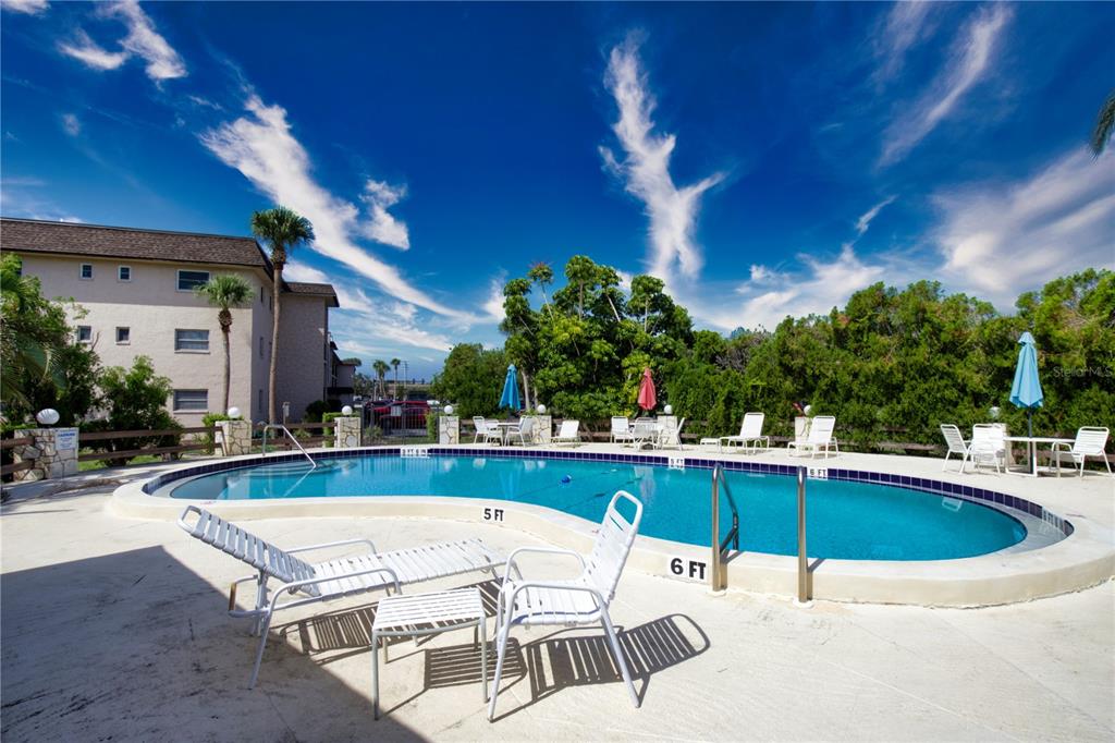 102 Capri Isles Boulevard, Unit 207 Venice, FL 34292 - Photo 2 of 25 a view of a swimming pool with a patio