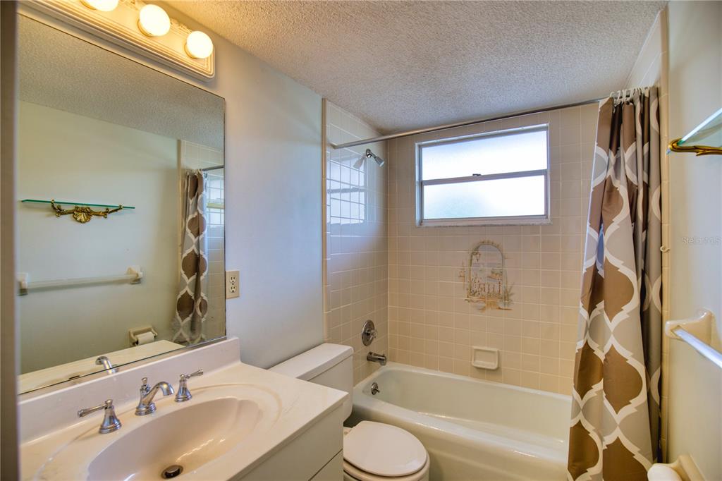 102 Capri Isles Boulevard, Unit 207 Venice, FL 34292 - Photo 21 of 25 a bathroom with a sink and a bathtub