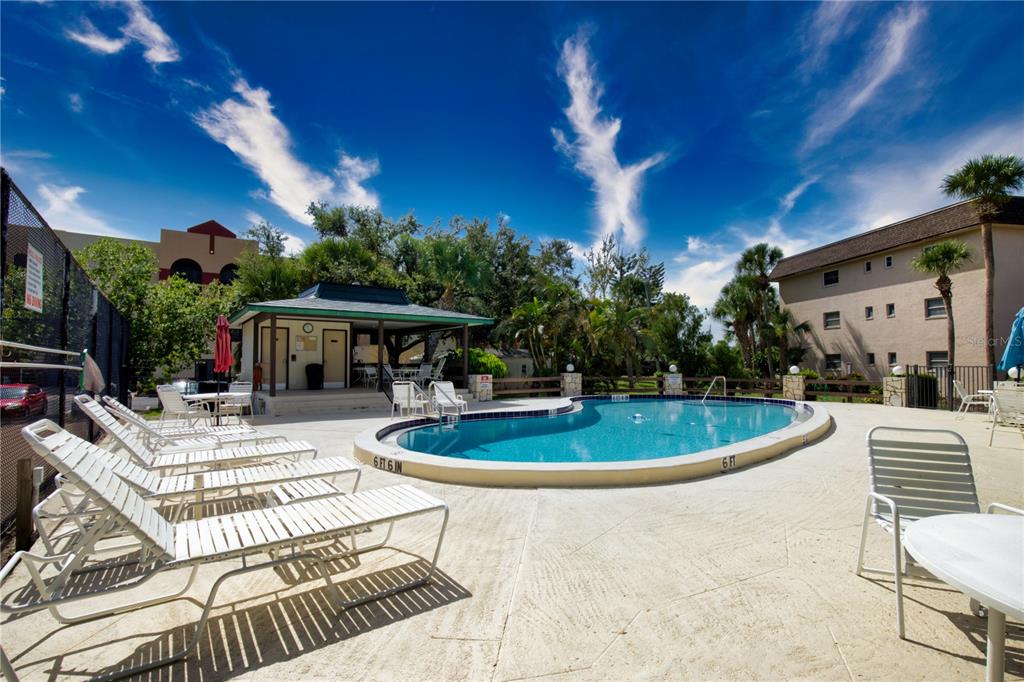 102 Capri Isles Boulevard, Unit 207 Venice, FL 34292 - Photo 24 of 25 a view of a house with backyard swimming pool and sitting area