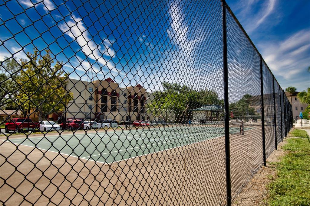 102 Capri Isles Boulevard, Unit 207 Venice, FL 34292 - Photo 25 of 25 a view of a pathway along a building