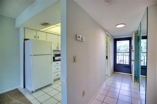a kitchen with a sink dishwasher a refrigerator and cabinets