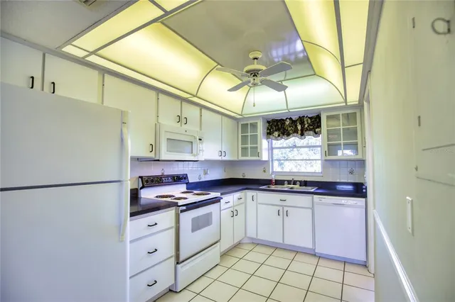 a kitchen with cabinets a sink and appliances