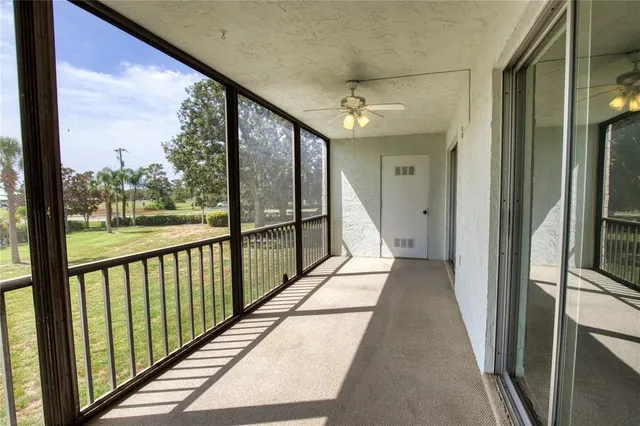 a view of a hallway with wooden floor and a cabinet