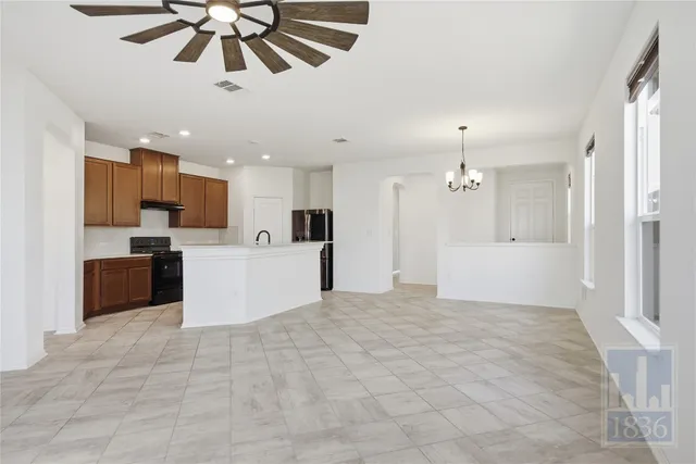 a view of a kitchen with an empty space and a window