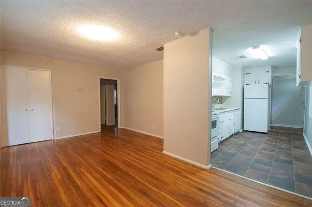an empty room with closet and wooden floor