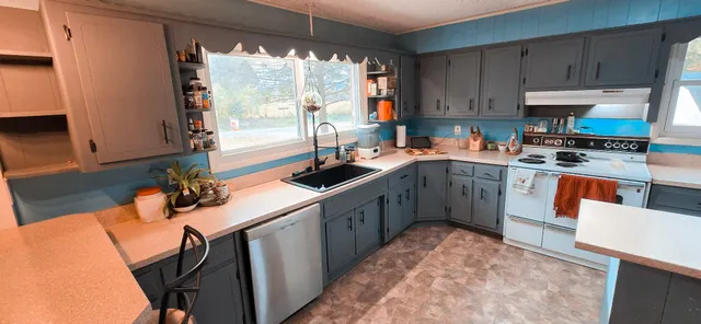 a kitchen with a sink stove and cabinets