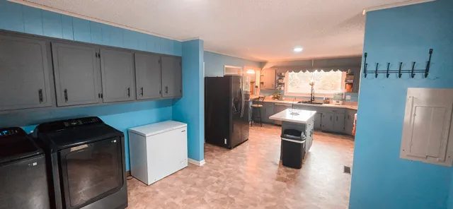 a kitchen with a refrigerator and a refrigerator