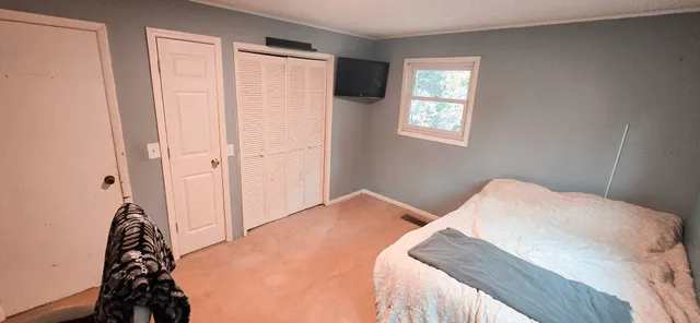 a bedroom with a bed and a window