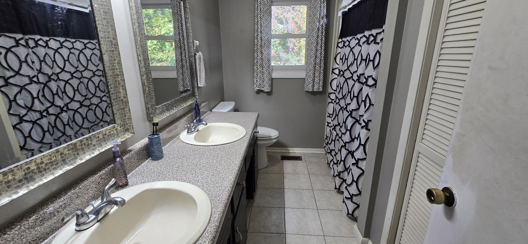 936 Ridge Road Quebeck, TN 38579 - Photo 26 of 32 a bathroom with a granite countertop sink a toilet and shower curtain