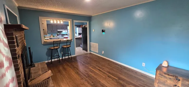 a view of a livingroom with furniture and wooden floor