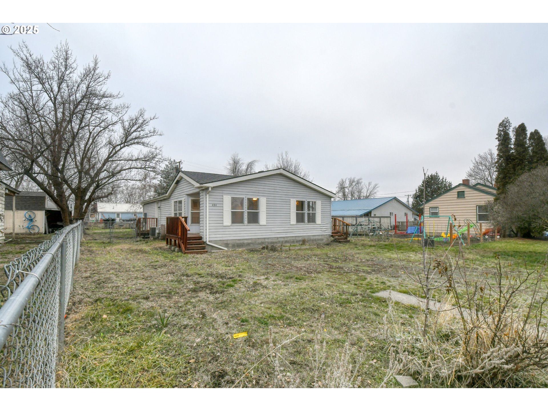 a house with green field in front of it