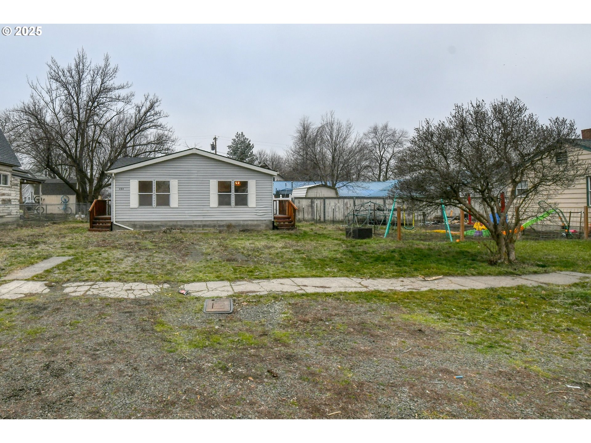 424 East High Street Athena, OR 97813 - Photo 3 of 40 a view of a house with a big yard and large trees