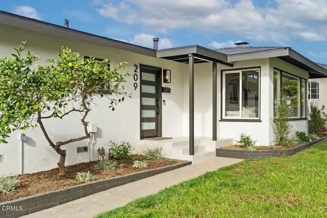 a front view of a house with garden