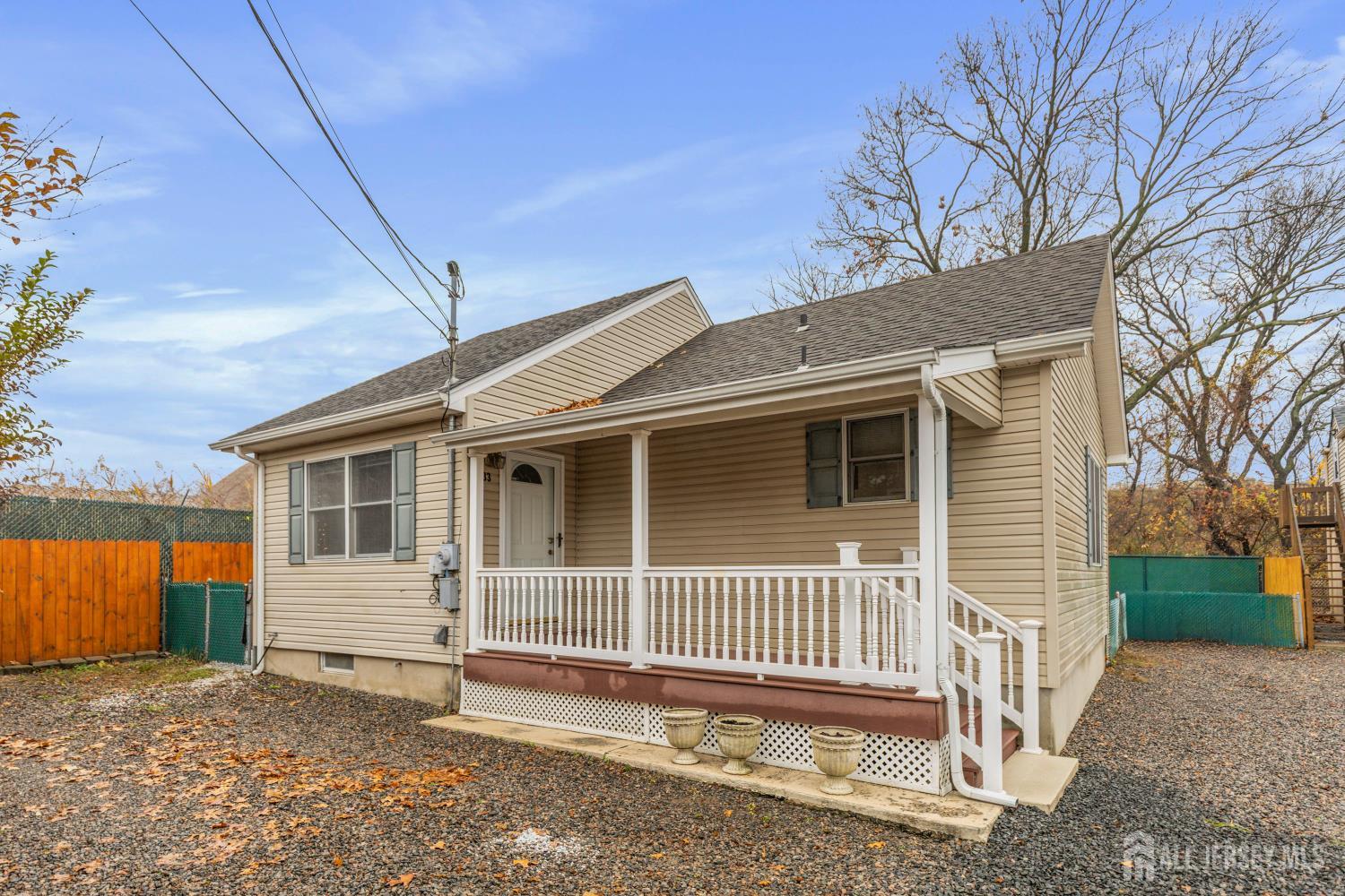 a view of a house with a yard and wooden fence